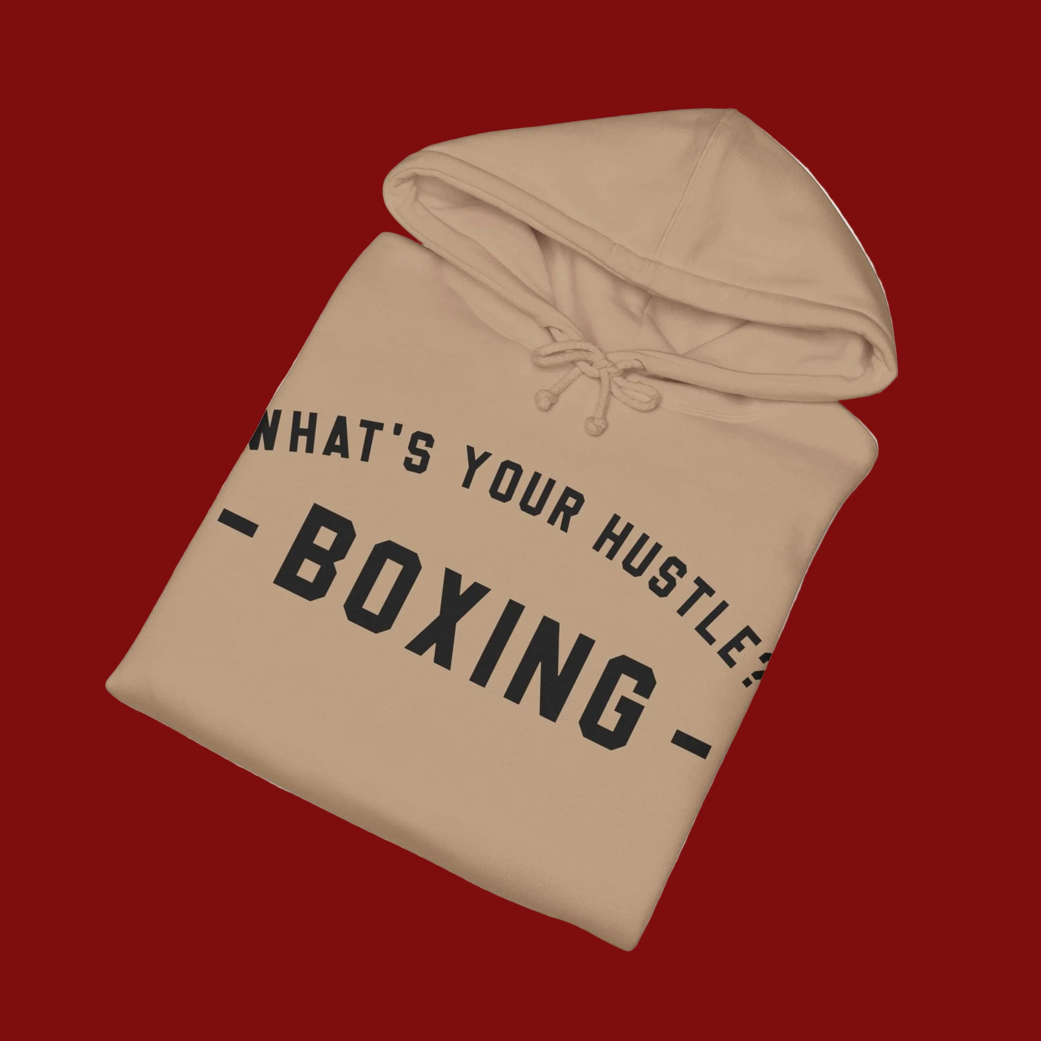A beige pullover hoodie with black text reading 'WHAT'S YOUR HUSTLE - BOXING -' printed on the front, shown on a clean white background.