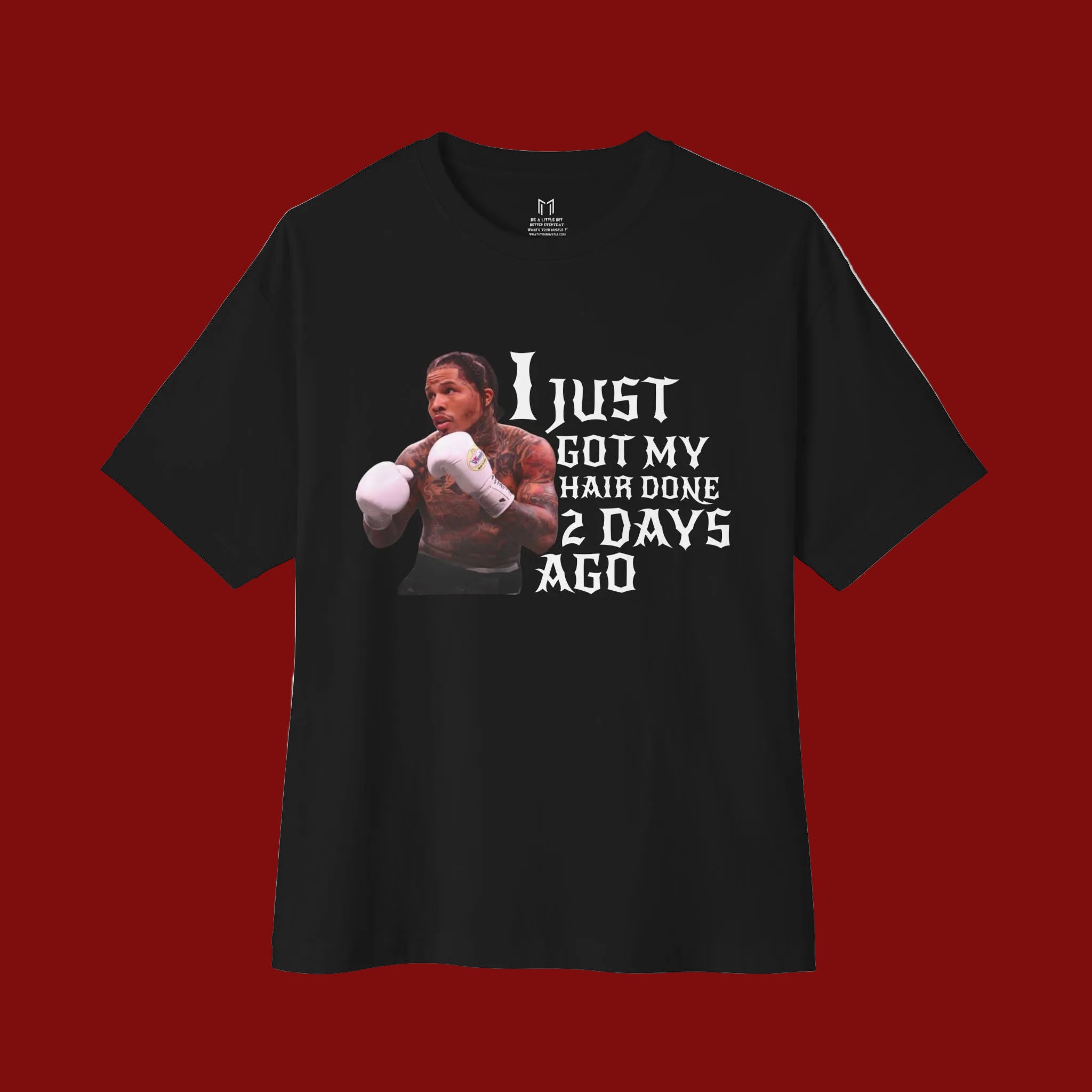 A black short-sleeve t-shirt with a graphic print of a boxer and the text 'I JUST GOT MY HAIR DONE 2 DAYS AGO' in white, displayed on a clean white background.