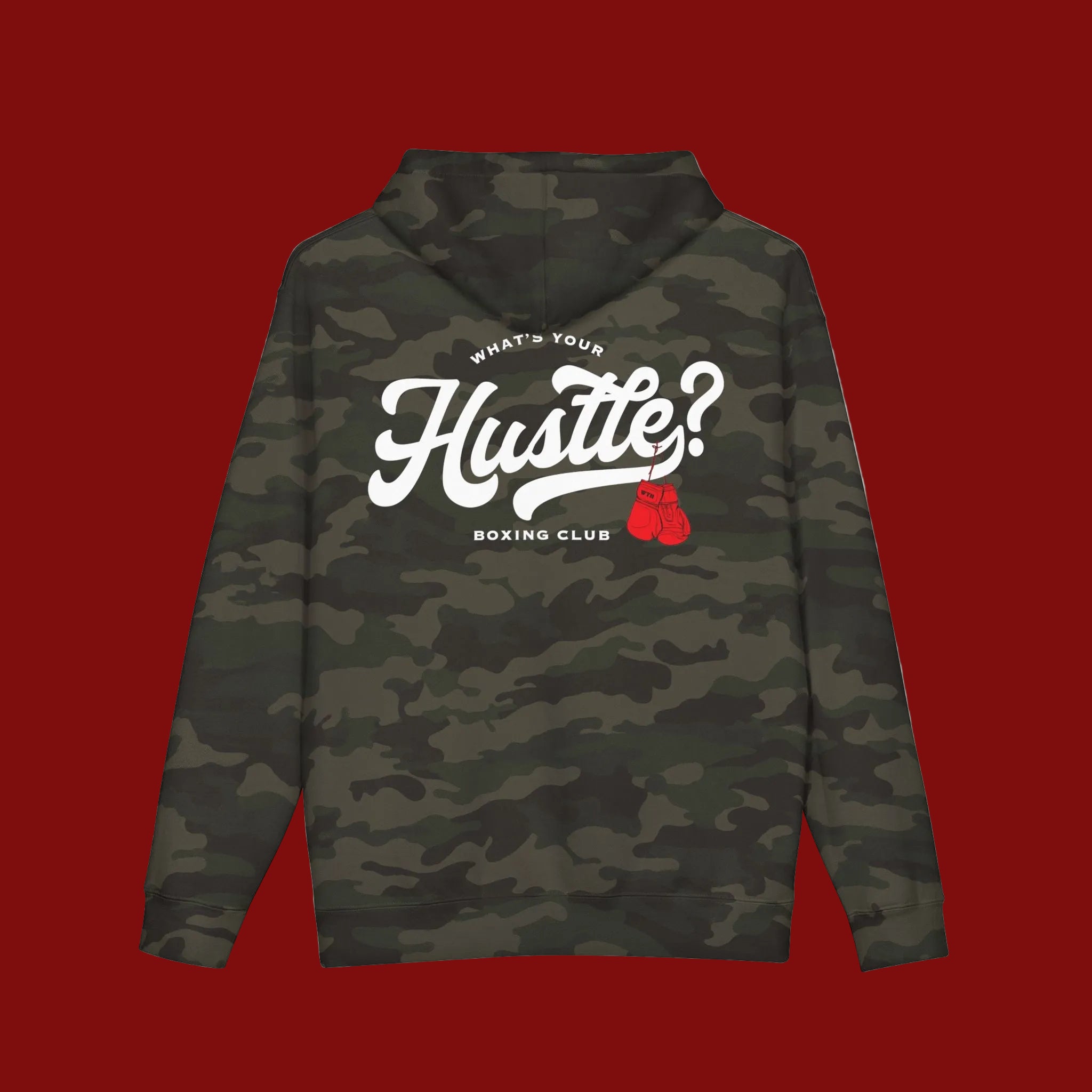 A long-sleeve hoodie with a dark green camouflage pattern, featuring a large white graphic on the back that reads 'WHAT'S YOUR Hustle? BOXING CLUB' with a small red boxing glove graphic.
