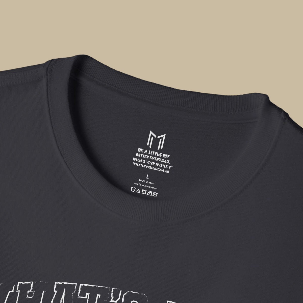 Close-up of a black crewneck t-shirt showing the inner neck label with a circular logo for Forge Garage Co.