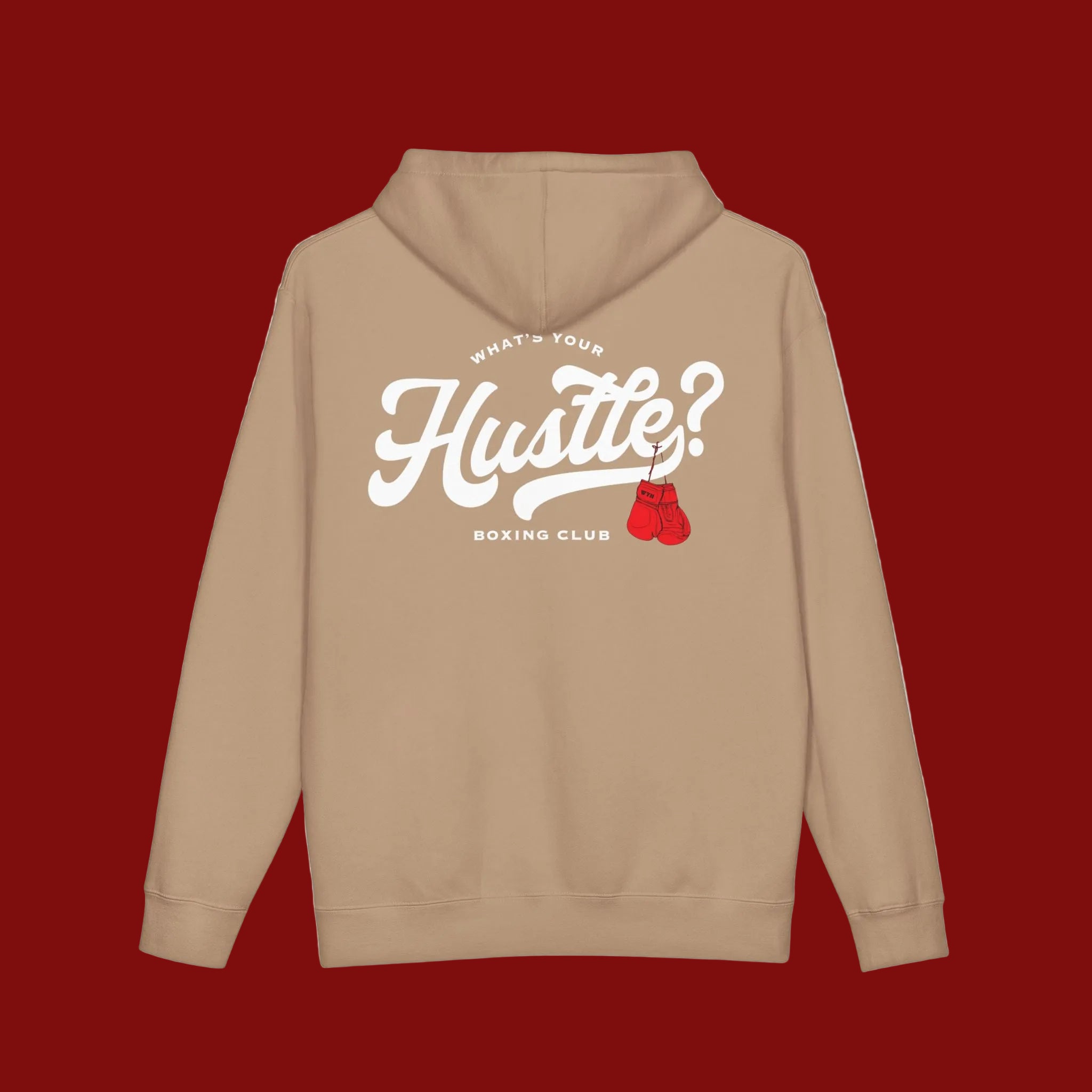 A tan hoodie shown from the back, featuring a large white graphic that reads 'Hustle?' with a red boxing gloves accent and smaller text reading 'WHAT'S YOUR BOXING CLUB'.