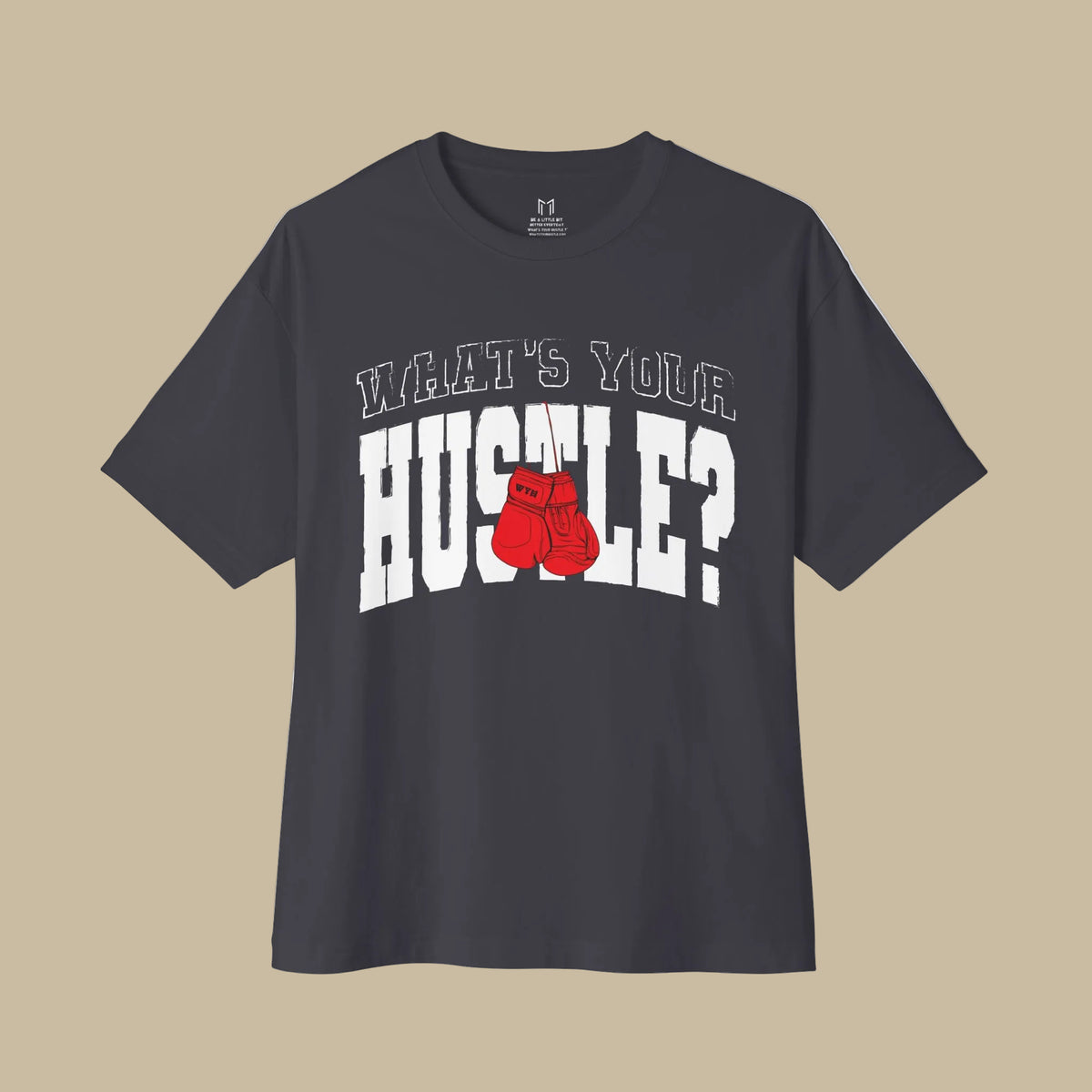 A dark charcoal gray short-sleeve t-shirt with a graphic on the front that reads 'WHAT'S YOUR HUSTLE?' in white outlined letters, with a pair of red boxing gloves replacing the letter 'O'.