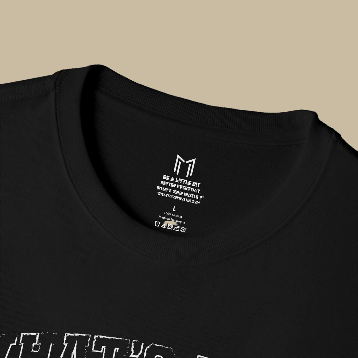 Close-up of a black crewneck t-shirt showing the inside collar with white printed text reading 'Wheelful Blessings' and size information, on a white background.